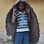 Bagata Boy Wearing Indegenous Rain Coat